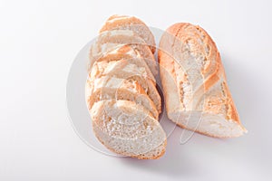 Freshly baked French baguettes on white wooden table