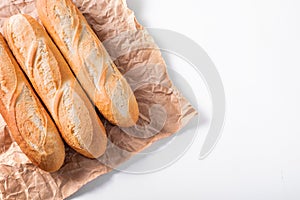 Freshly baked French baguettes on white wooden table