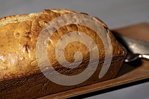 Freshly baked golden Banana Bread on a wood tray