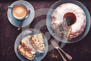 Freshly baked gugelhupf with a cup of coffee crema