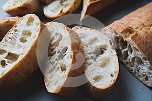 Freshly baked homemade bread with crispy crust on gray background