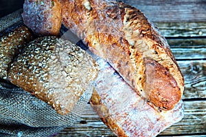 Freshly baked homemade bread on rustic wooden background.