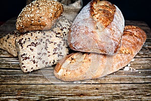 Freshly baked homemade bread on rustic wooden background.