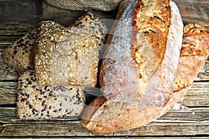 Freshly baked homemade bread on rustic wooden background.