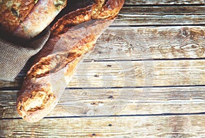 Freshly baked homemade bread on rustic wooden background.
