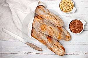Freshly baked homemade cereal baguettes with oatmeal and flax seed