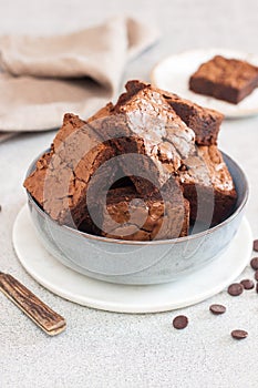 Freshly baked homemeade hocolate chewy brownie in grey bowl photo