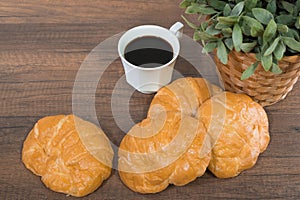 Freshly baked homemade croissants on wooden cutting board