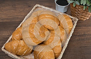 Freshly baked homemade croissants on wooden cutting board