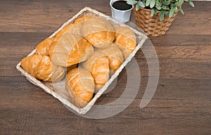 Freshly baked homemade croissants on wooden cutting board