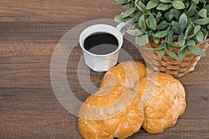 Freshly baked homemade croissants on wooden cutting board