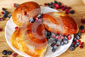 Freshly baked homemade pies on a plate decorated with berries