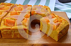 Freshly Baked Homemade Pumpkin Cake on Wooden Breadboard