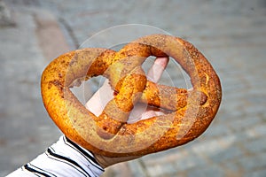 Freshly baked homemade Vyborg Pretzel with cinnamon and sea salt. German beer appetizer. Traditional savory pastries