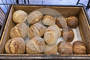 Freshly baked loaves of bread on a market stall.