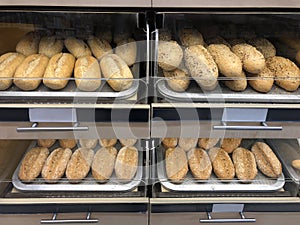 Freshly baked loaves of white bread on the shelves