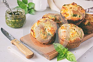 Freshly baked muffins with spinach, sweet potatoes and feta cheese on white background. Healthy food concept. Savory pastry