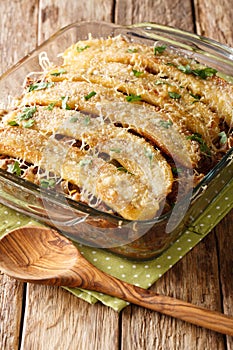 Freshly baked pastelon de Platano Maduro casserole close-up in a baking dish. vertical