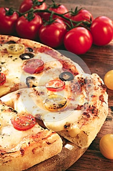 Freshly Baked Pizza with tomatoes, olives and cheese