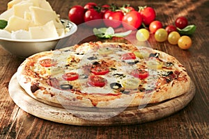 Freshly Baked Pizza with tomatoes, olives and cheese