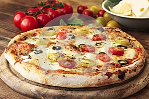 Freshly Baked Pizza with tomatoes, olives and cheese