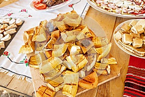 Freshly baked pumpkin desert right from the oven cut in large pieces on a wooden table