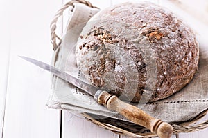 Freshly baked rye bread cob over white wooden background