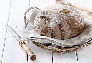 Freshly baked rye cob bread over white wooden background