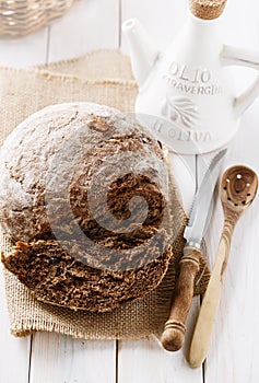 Freshly baked rye cob loaf over white wooden background