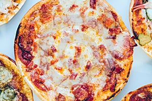 Freshly baked and sliced traditional pizza on a plate, closeup