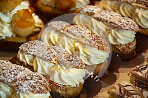 Freshly baked stuffed sweet Paris-Brest pastries in traditinal French bakery in small village in Provence