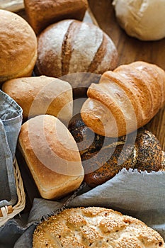 Freshly baked tasty white flour rhye and multi grain floor loafs of rectangular round and oval breads and plaited challah bread at