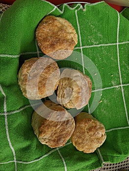Freshly baked tea biscuits on a dish towel