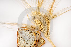 Freshly baked traditional bread with ears of wheat.