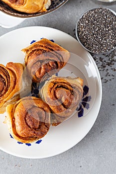 Freshly baked wheat buns with poppy seeds on the white plate