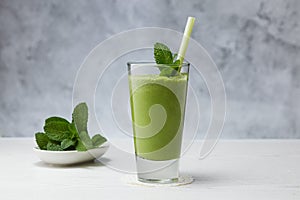 Freshly blended green fruit smoothie in glass