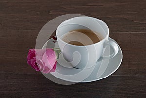 Freshly brewed coffee served with beautiful rose flowers.