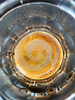 Freshly brewed espresso shot in glass top view. Coffee aesthetics