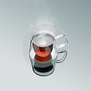 Freshly brewed hot black tea in double sided modern transparent glass mug.