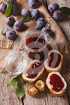 Freshly brewed plum jam and toast close-up. vertical top view