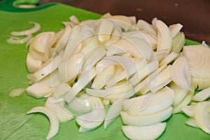 Freshly Chopped Onions on Bright Green Cutting Board Close-Up