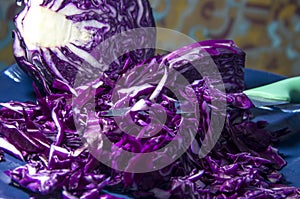 Freshly chopped red cabbage close-up on an abstract background.