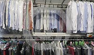 Freshly cleaned men`s shirts and ladies blouses in a textile cleaning