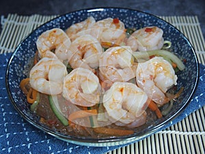 Freshly cooked cellophane noodles with shrimps served in a blue plate