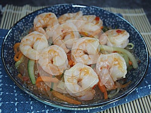 Freshly cooked cellophane noodles with shrimps served in a blue plate