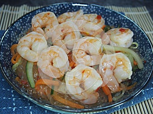 Freshly cooked cellophane noodles with shrimps served in a blue plate