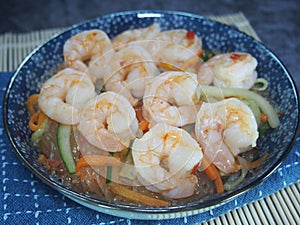 Freshly cooked cellophane noodles with shrimps served in a blue plate