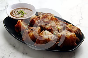 Freshly cooked Filipino food called Lechon Kawali or pan fried chopped crispy pork belly