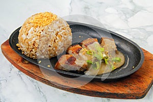 Freshly cooked fried pork belly served with garlic rice and gravy