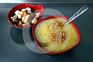 Freshly cooked Goto or rice porridge with beef innards and bowl of fried tofu